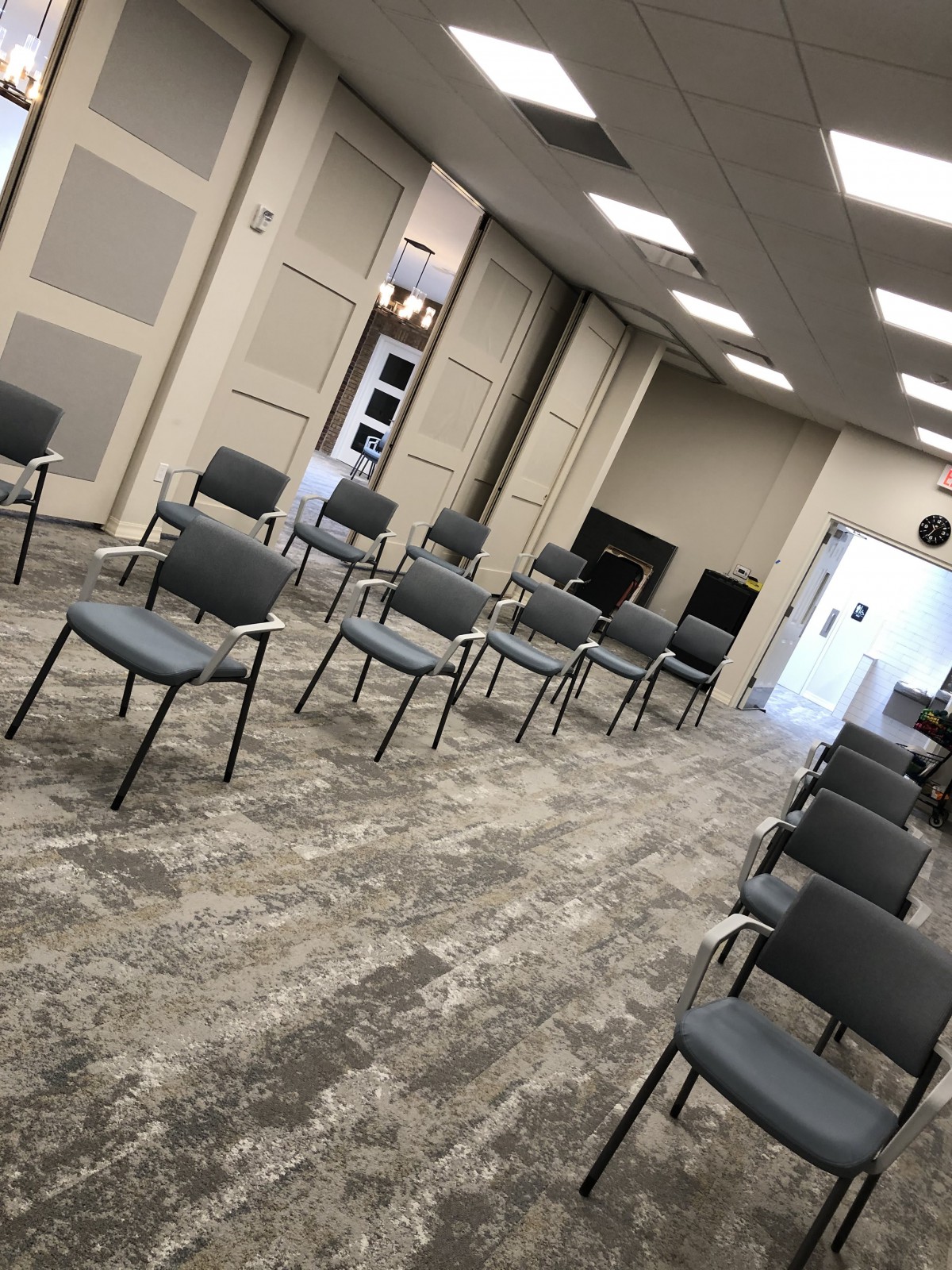 An indoor meeting space with chairs arranged in rows.