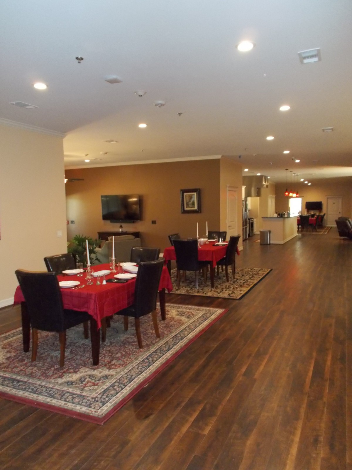 A cozy dining area with neatly arranged tables and chairs, set in a warmly lit indoor space.