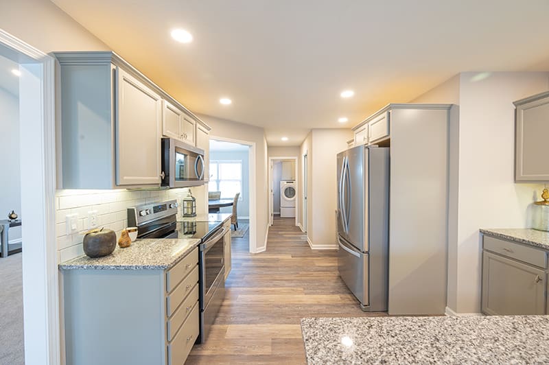 Modern kitchen with sleek appliances and bright lighting.
