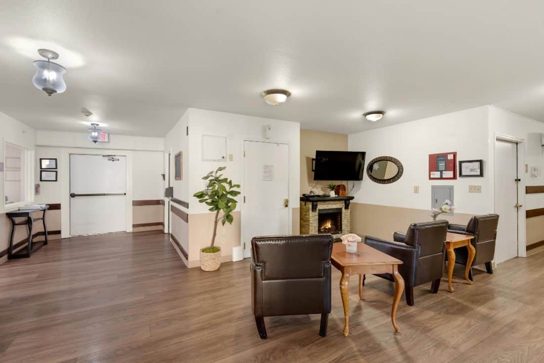 A cozy living room featuring comfortable seating, a television, and a fireplace.