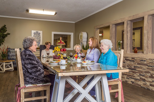 A warm gathering of friends enjoying tea and conversation in a cozy indoor setting.