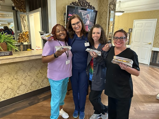Healthcare staff enjoying a moment together with snacks.