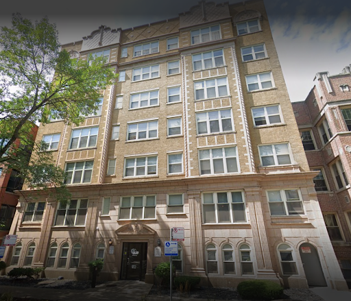 A view of a classic six-story apartment building showcasing architectural details.