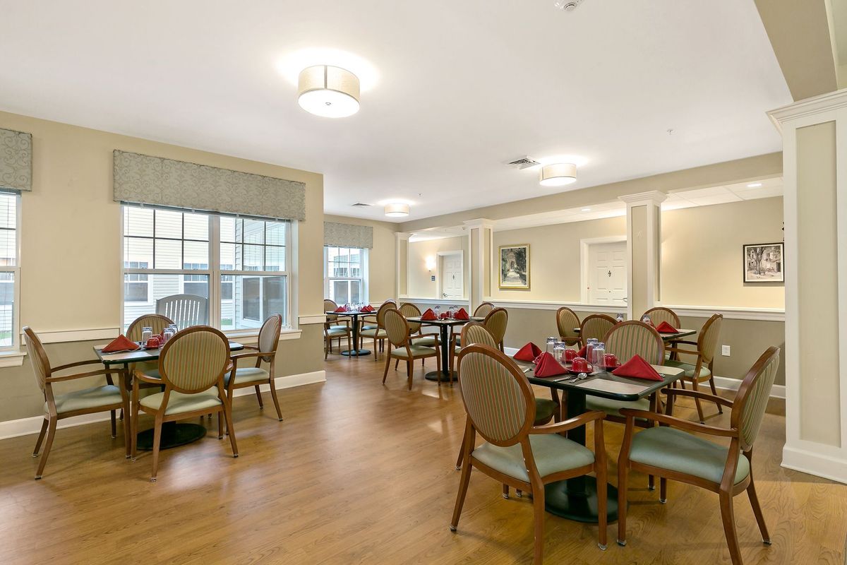 An elegantly decorated dining area with neatly arranged tables and chairs.