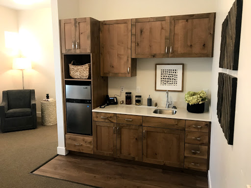 A cozy kitchen setup featuring warm wood cabinetry and modern appliances.