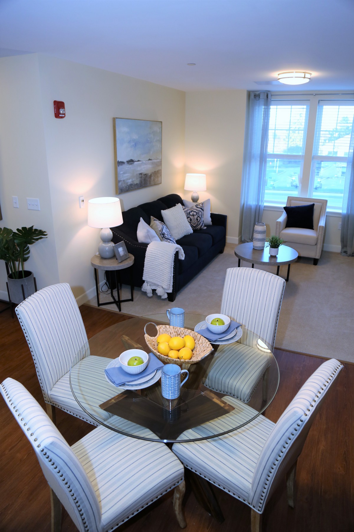 A cozy and inviting living room with a connected dining area featuring modern furniture and tasteful decor.