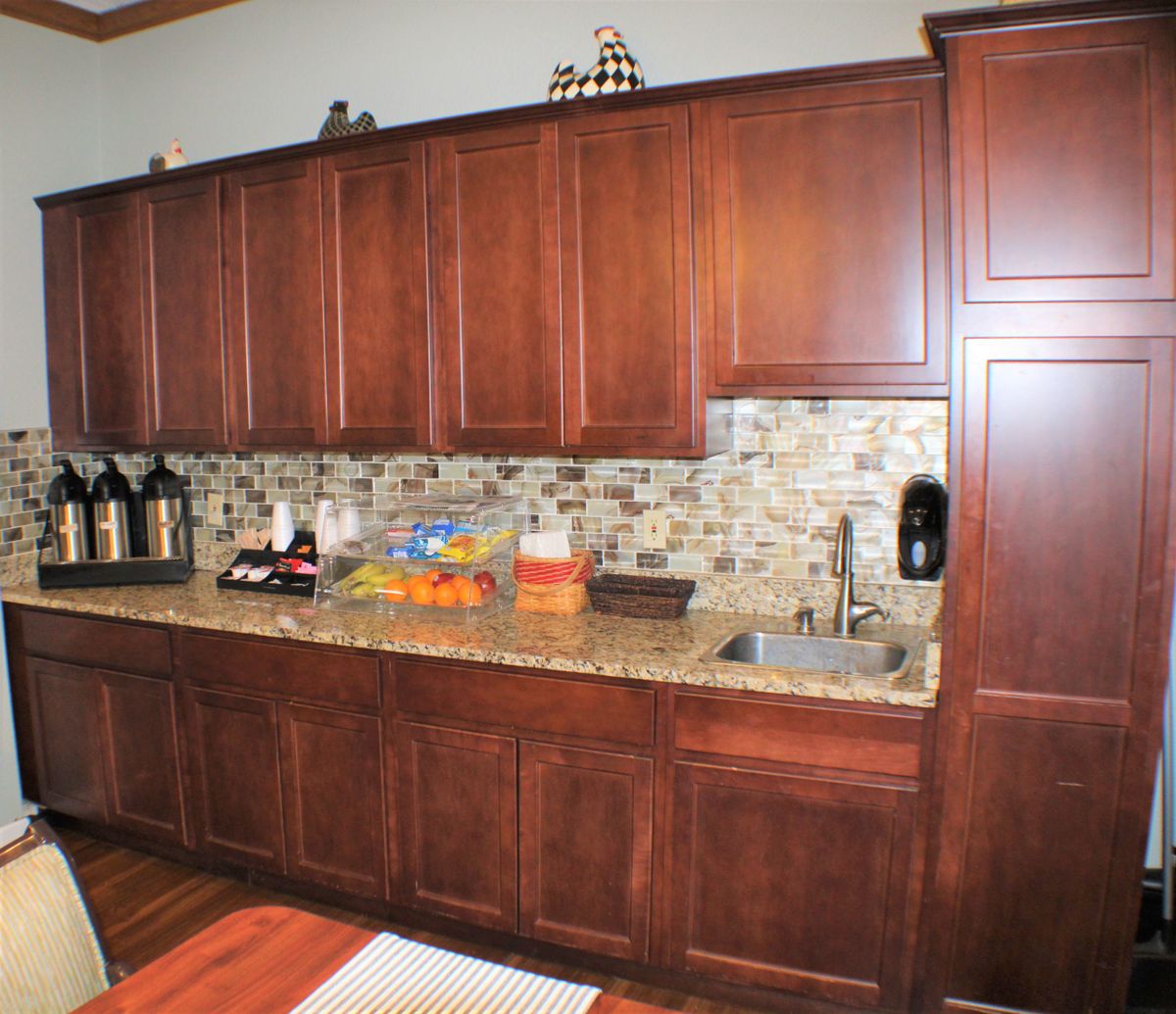 A modern kitchen with wooden cabinets and a granite countertop.