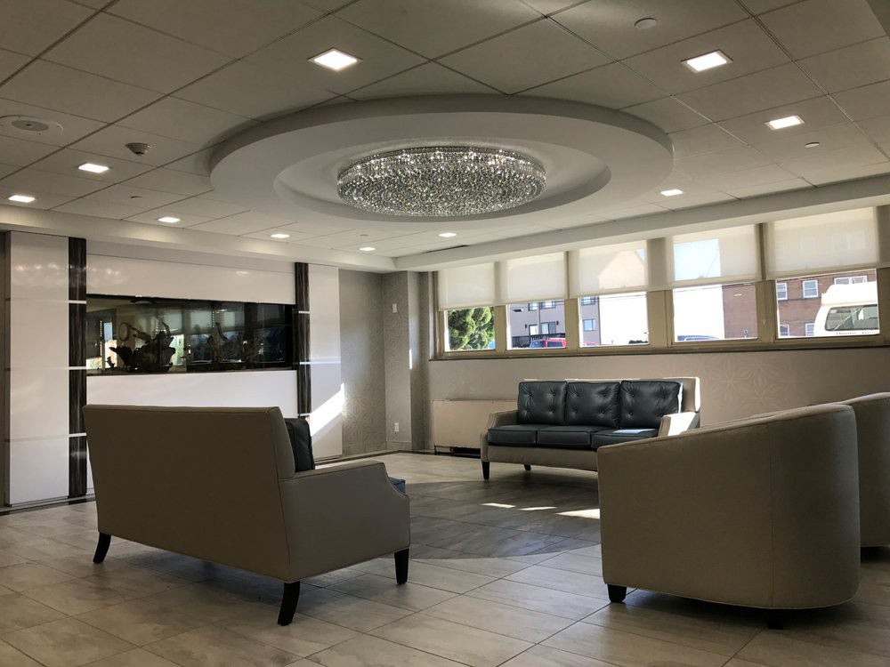 A modern lobby with comfortable seating and a stylish chandelier.