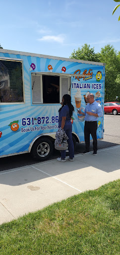 A bright summer day with people enjoying Italian ice from a food truck.