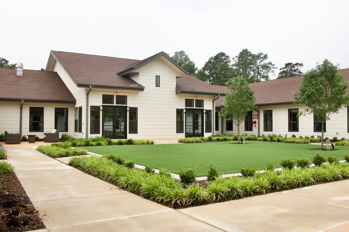 A well-landscaped front yard of a modern residential house.