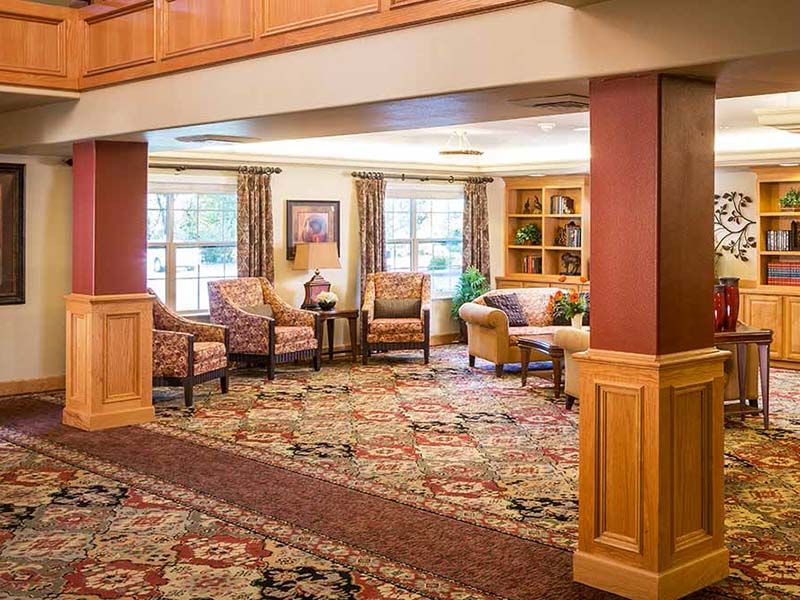 A cozy living room with comfortable seating and a patterned carpet.