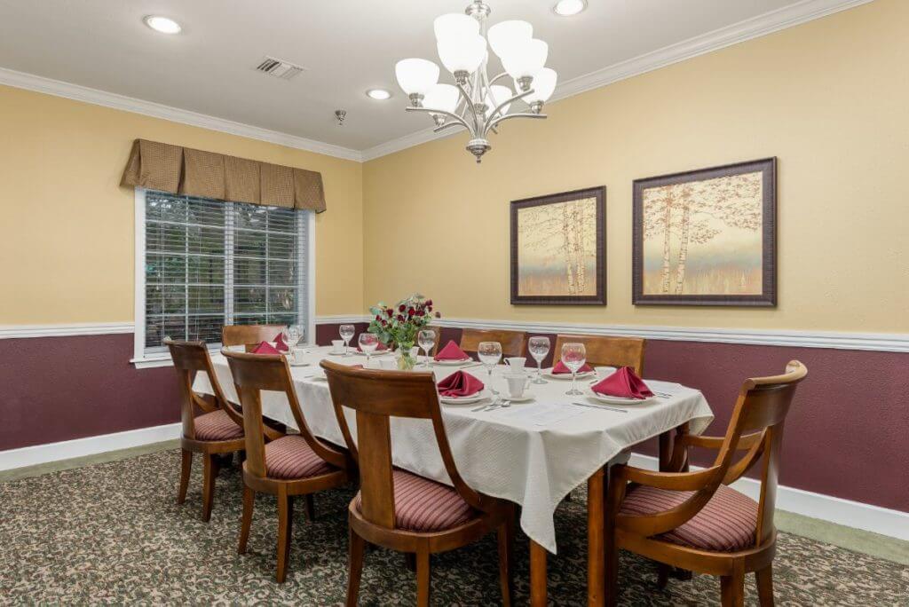 A cozy dining room with a set table and elegant decor.