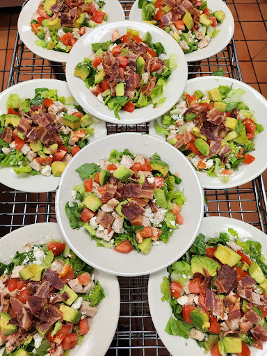 A vibrant assortment of fresh salads beautifully arranged on plates.