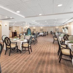 A spacious and elegantly decorated dining area with neatly arranged tables and chairs.