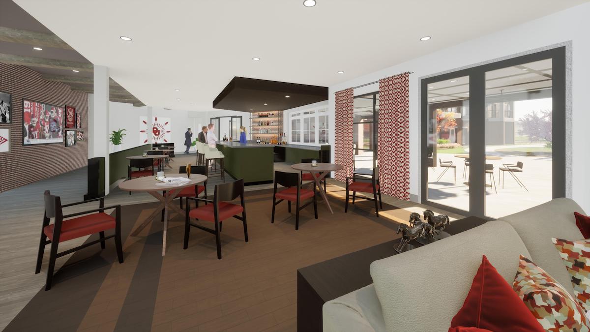 A modern cafe interior with tables, chairs, and a brick accent wall.