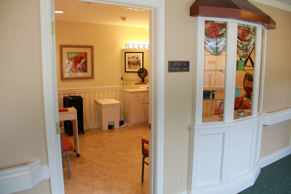 An open door view of a clinic room with waiting area and furniture.