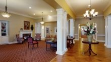 A spacious living room with elegant columns and comfortable seating.