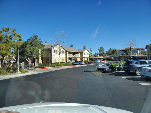 A view of a residential apartment complex with a clear blue sky.