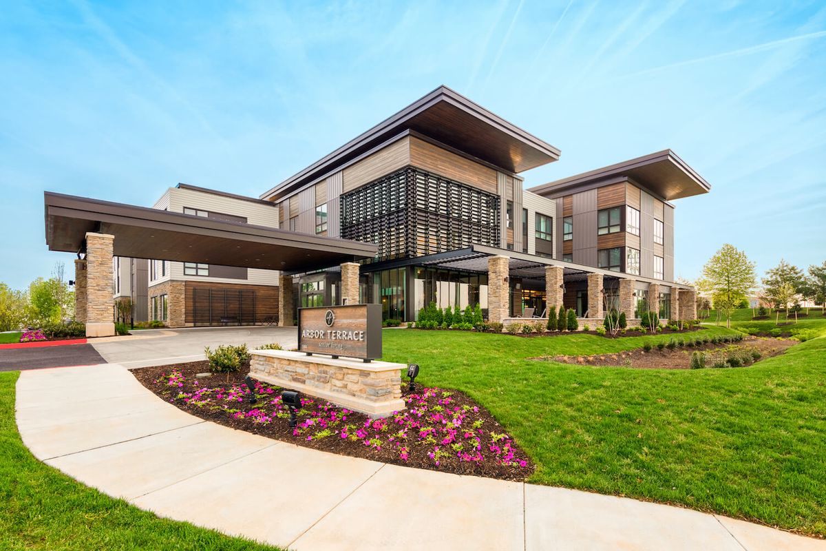 A modern building with a sleek design and well-maintained landscaping.