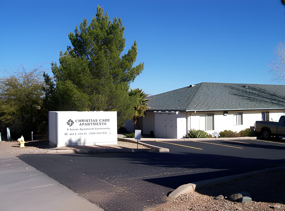 Exterior view of a clinic with signage and surrounding trees on a clear day.