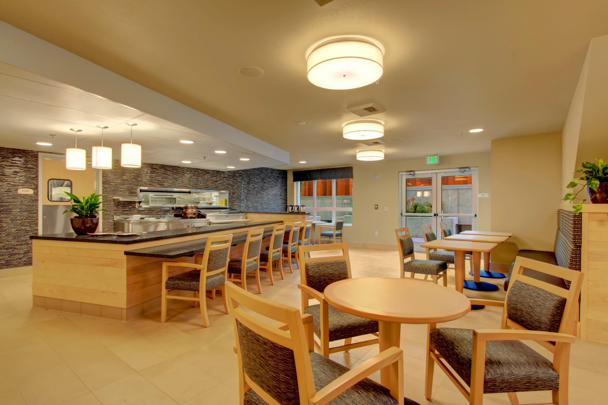 A modern dining area with tables, chairs, and ambient lighting.