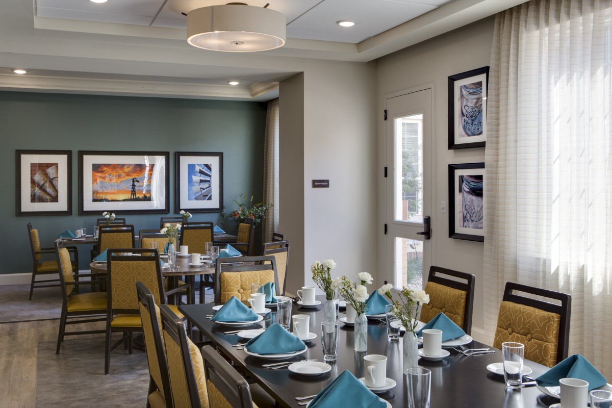 A modern dining room with elegant table settings and contemporary decor.