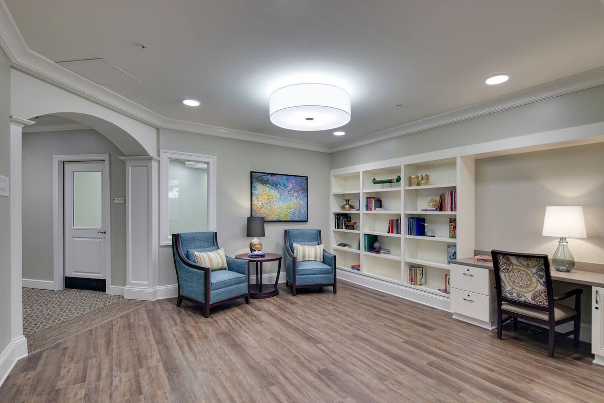 A modern living room with comfortable seating and a built-in bookshelf.