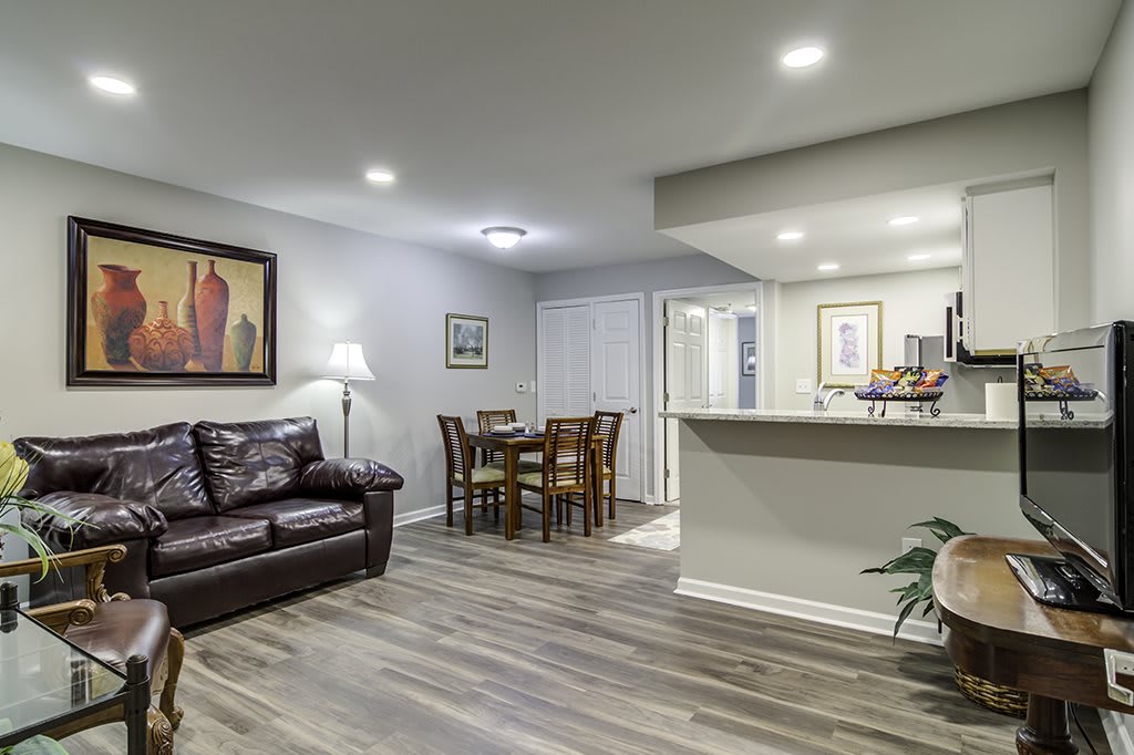 A modern living room with a cozy seating area, dining table, and contemporary decor.