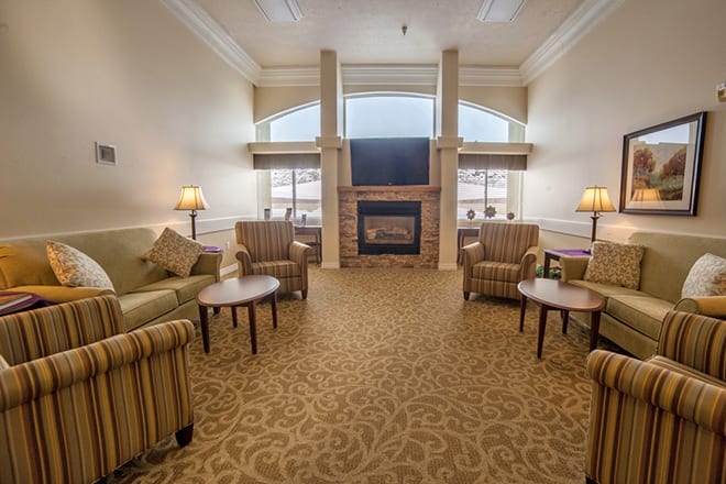 A cozy living room with a fireplace and comfortable seating.