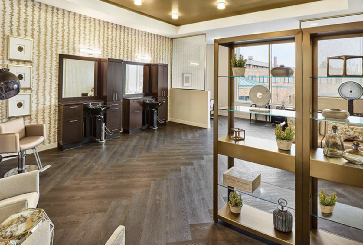 A stylish salon interior featuring modern hairdressing stations and chic decor.