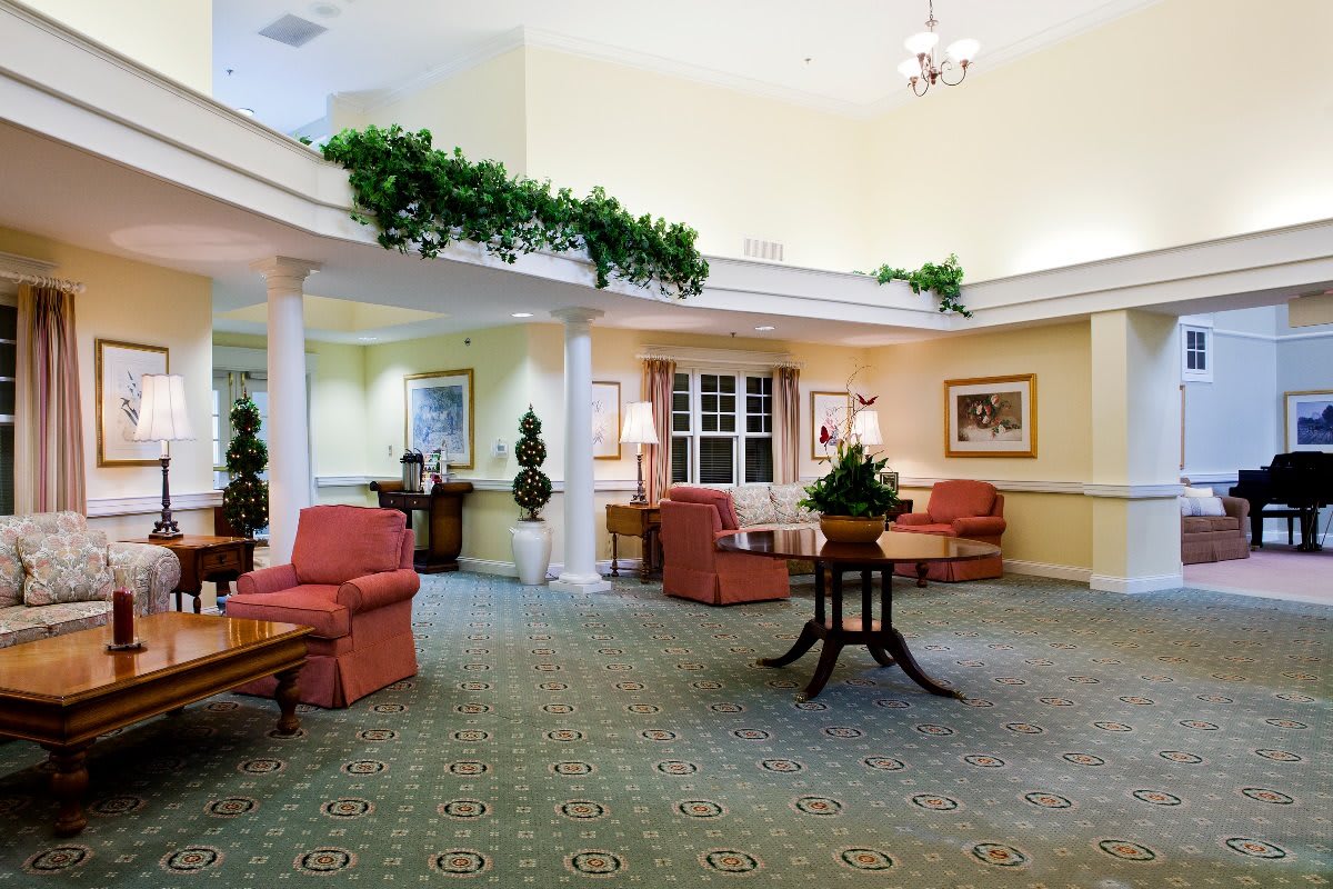 A spacious lobby with comfortable seating, decorative plants, and a welcoming atmosphere.