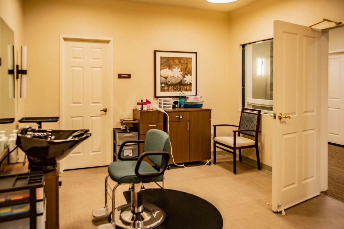 A well-organized office with seating and decor.