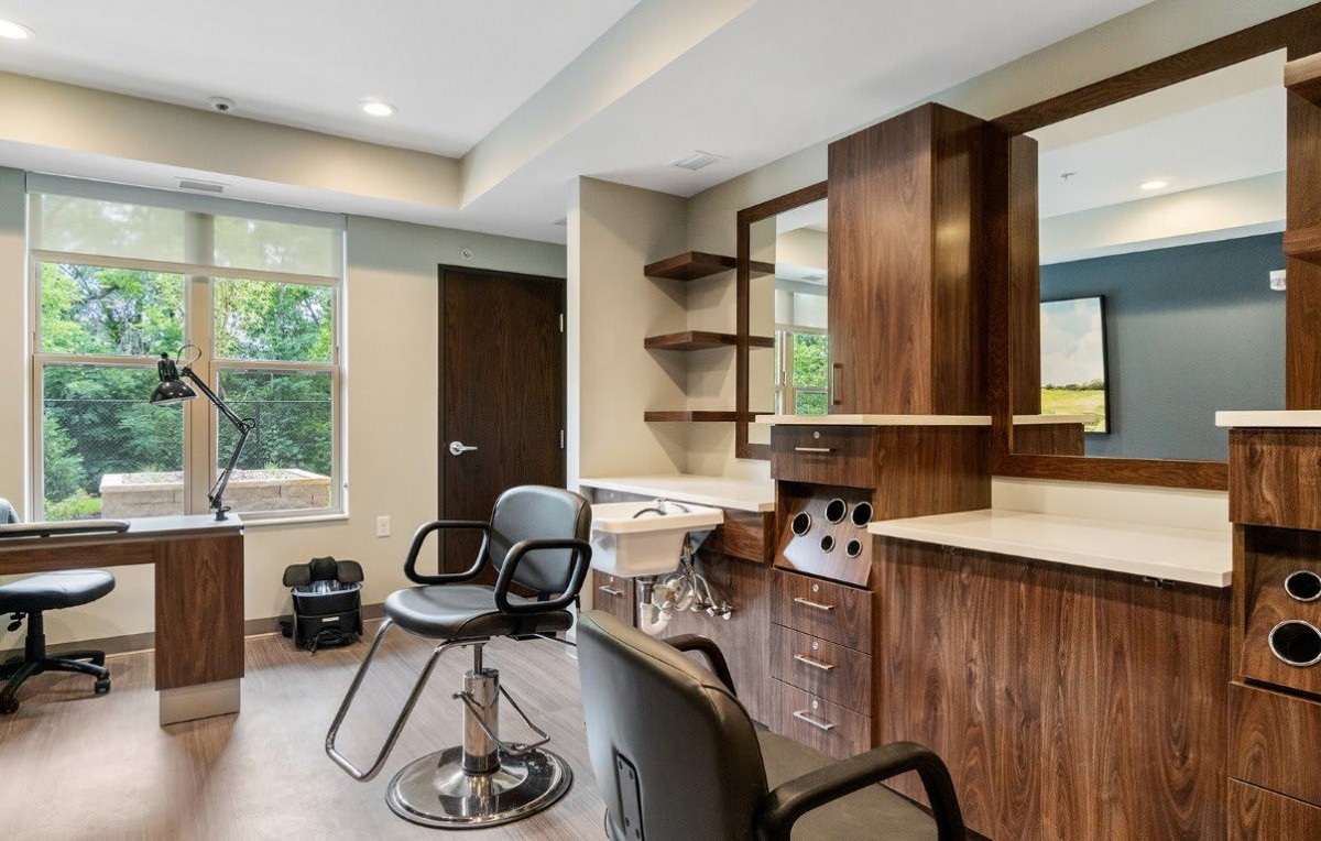 Modern hair salon interior with styling chairs and mirrors.