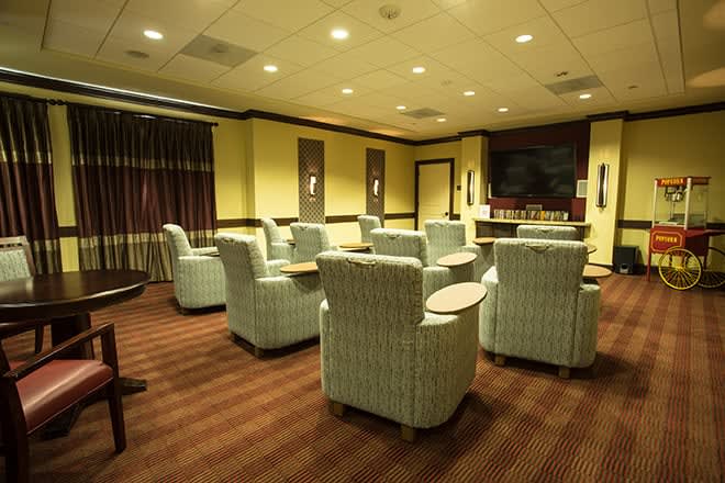 A comfortable lounge area with arranged seating and warm lighting.