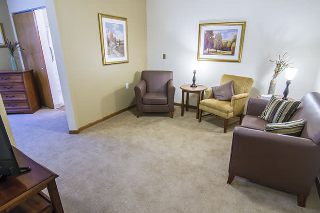 A cozy living room with comfortable seating and decorative artwork.