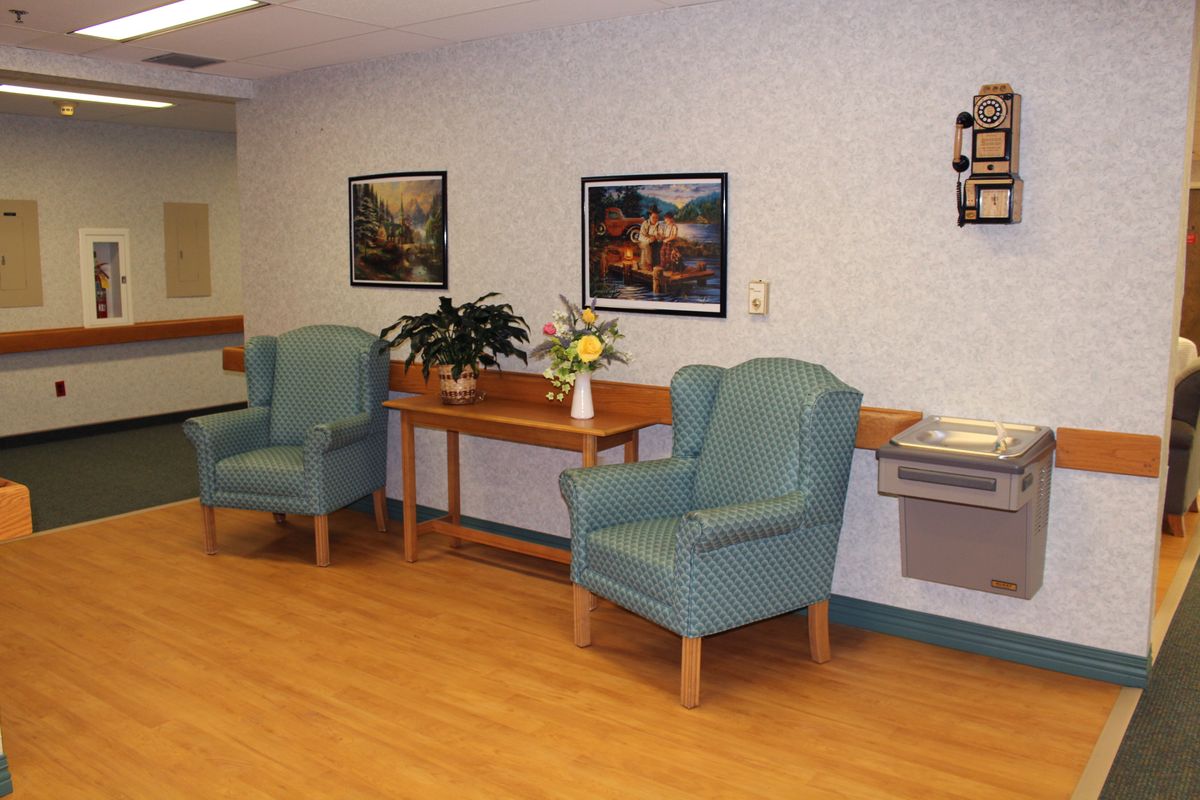 A well-decorated waiting area with comfortable seating and art on the walls.