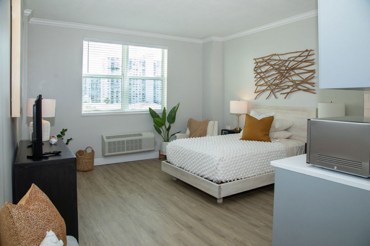 A modern, minimalist bedroom with white walls and tasteful decor.