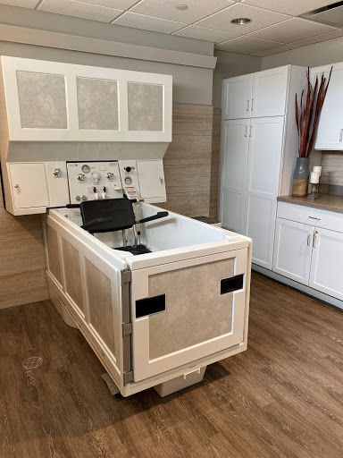 A modern kitchen setting featuring a unique sink with cabinetry above.