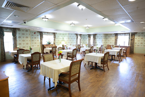 A spacious and elegantly designed dining room with neatly arranged tables and chairs.