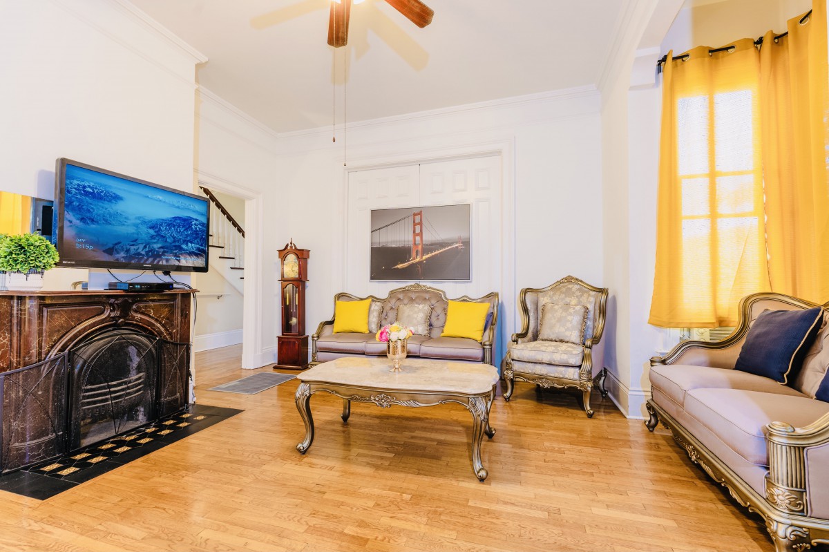 A cozy living room featuring elegant furniture, a TV, and warm decor.