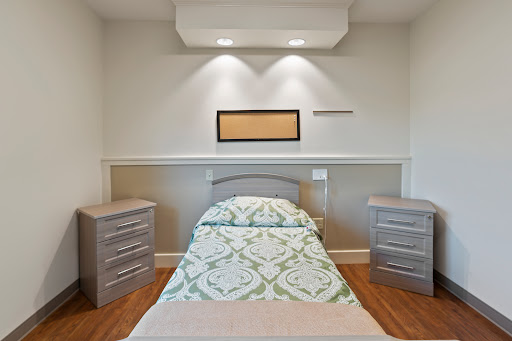 A serene and minimalist bedroom featuring a neatly made bed, stylish nightstands, and soft lighting.