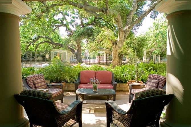 A cozy outdoor seating area in a lush garden setting.