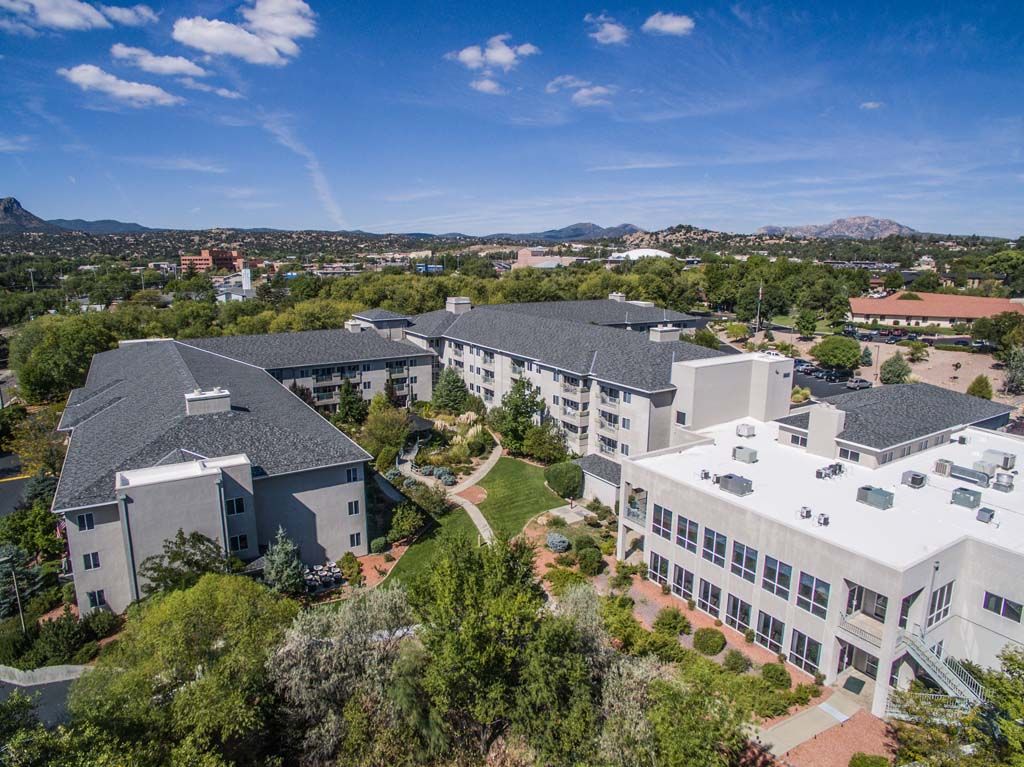 Aerial view of a large campus with modern buildings and green surroundings.