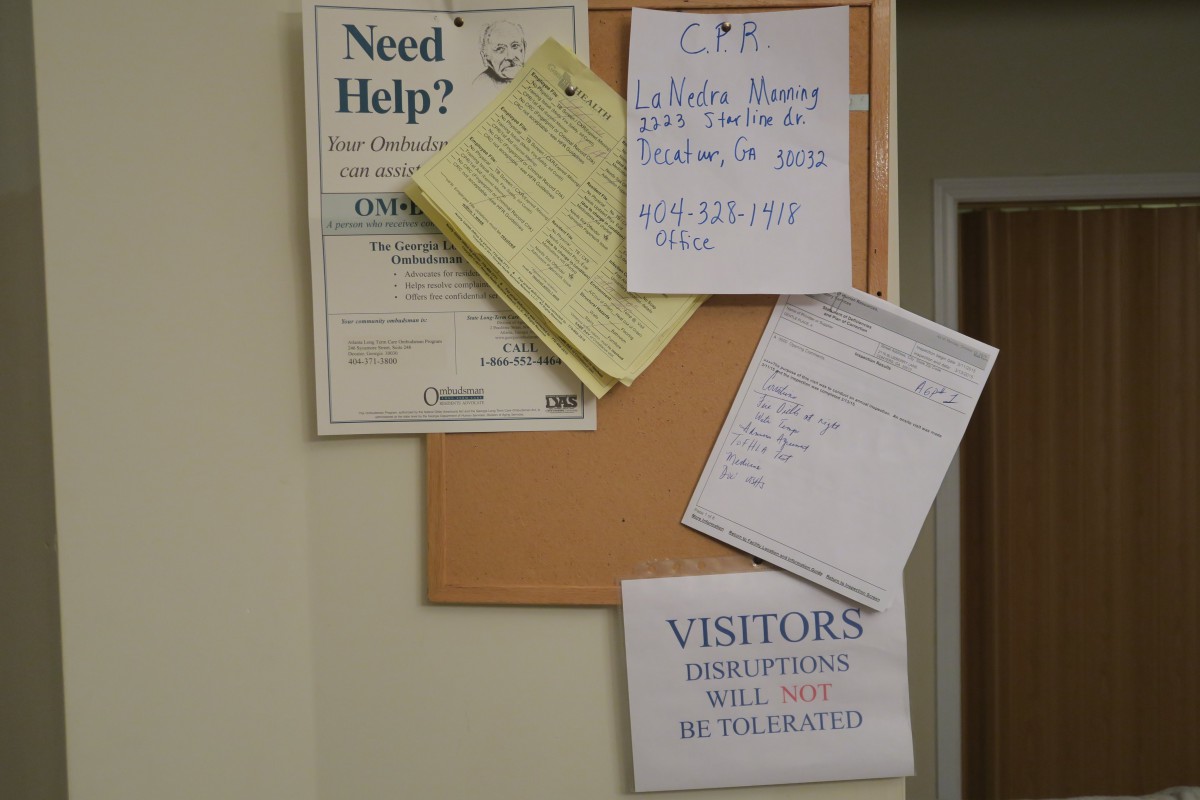 A bulletin board displaying various notices and informational papers.
