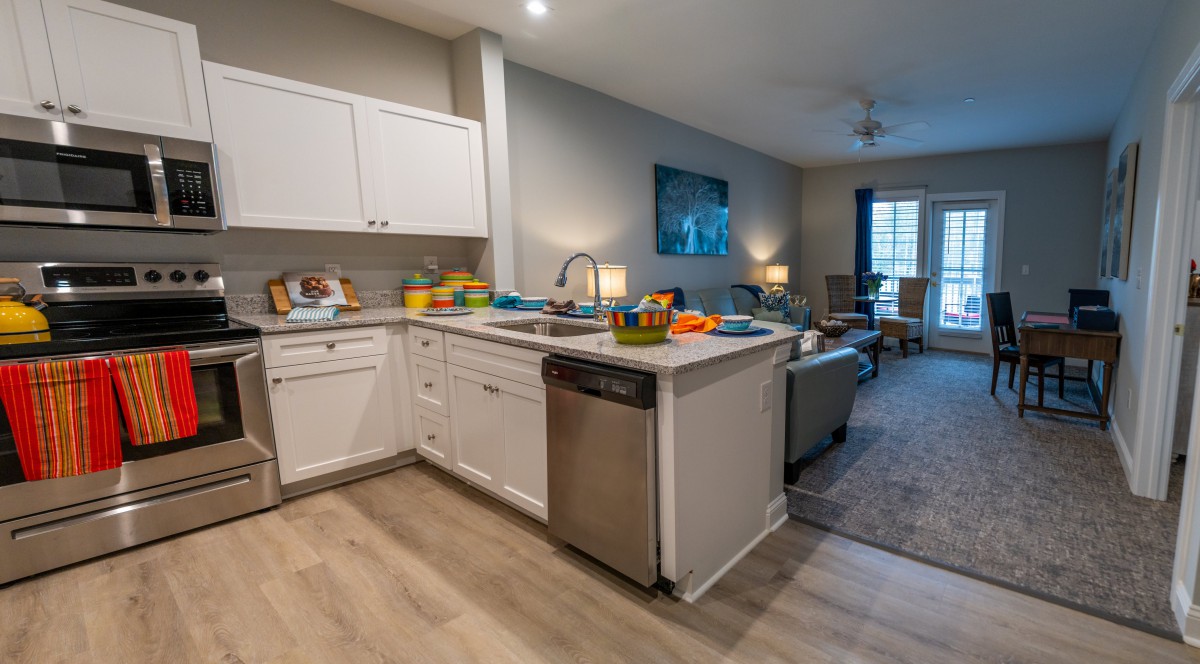 A modern open-concept kitchen and living room with stylish furnishings and appliances.