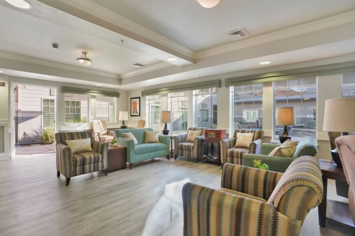A well-lit modern living room with comfortable seating and stylish decor.