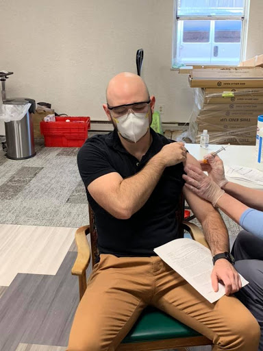 A patient receiving a COVID-19 vaccination at a healthcare facility.