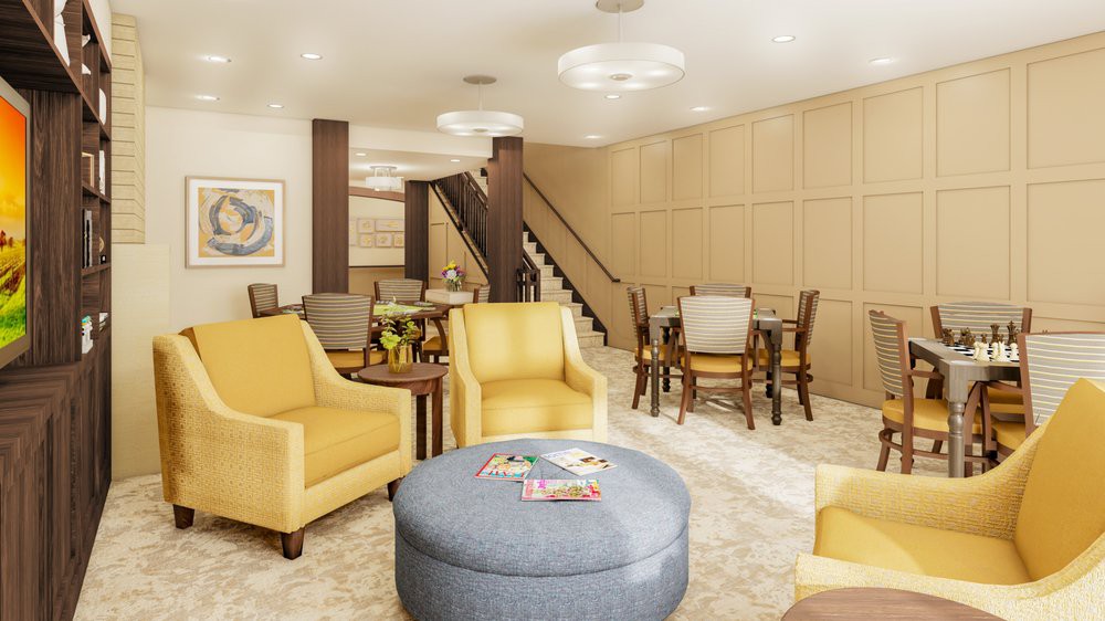 A modern and comfortable living room with yellow chairs and a staircase in the background.