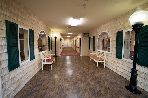 A well-lit hallway with decorative walls and benches on either side.
