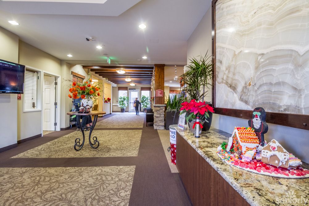 A well-decorated lobby area with plants and festive decorations.
